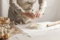 WomenÃ¢â¬â¢s hands, flour and dough. A woman is preparing a dough for home baking.